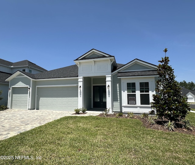 206 Holly Ridge Way, Saint Augustine, FL 32092 - view of front of house with a garage, a front yard, decorative driveway, and a shingled roof