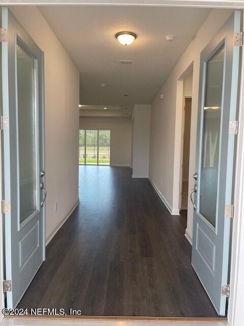 hallway featuring dark wood-type flooring