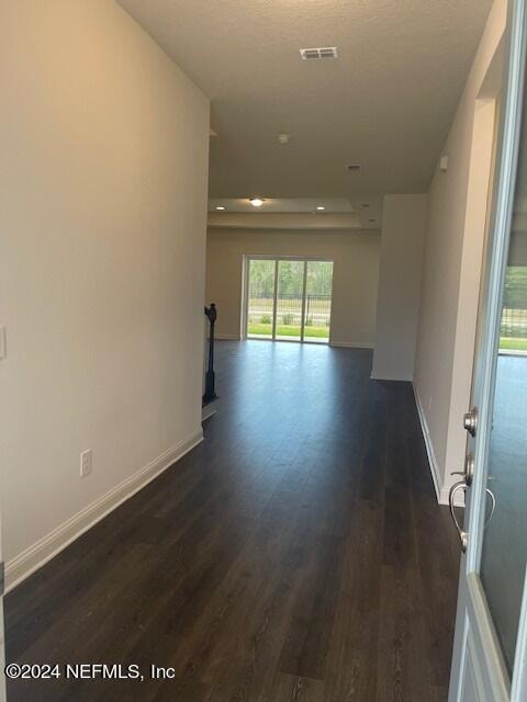 unfurnished room with dark hardwood / wood-style floors