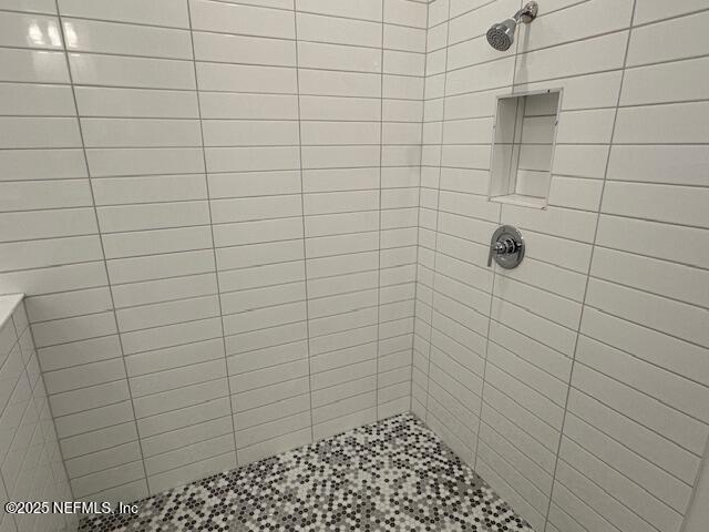 bathroom with tiled shower