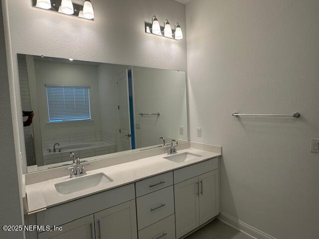 bathroom with vanity and a bathtub