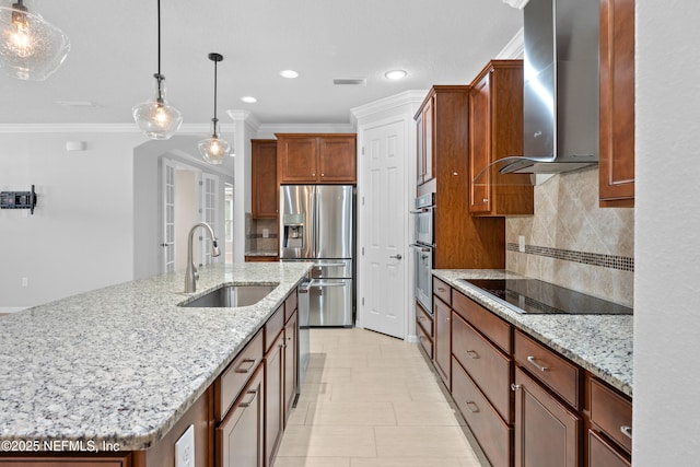 kitchen featuring wall chimney range hood, stainless steel appliances, sink, a kitchen island with sink, and light stone counters