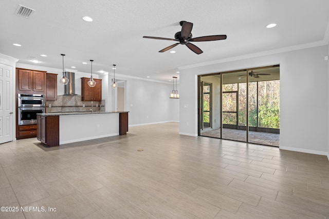 unfurnished living room featuring ceiling fan and ornamental molding