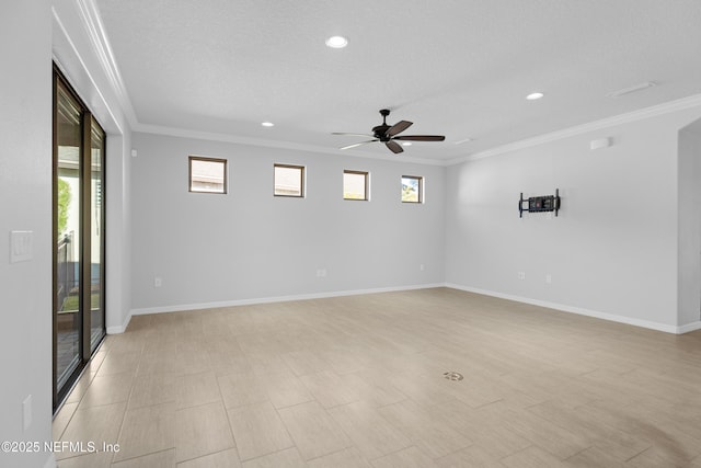 spare room featuring ceiling fan, ornamental molding, and a textured ceiling