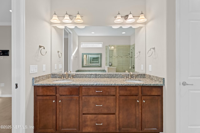 bathroom featuring a shower with shower door and vanity