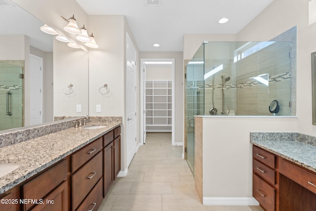 bathroom with vanity, tile patterned flooring, and a shower with door