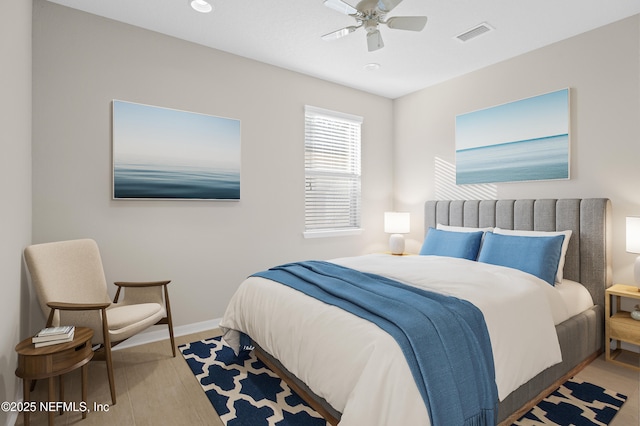 bedroom with ceiling fan and hardwood / wood-style flooring