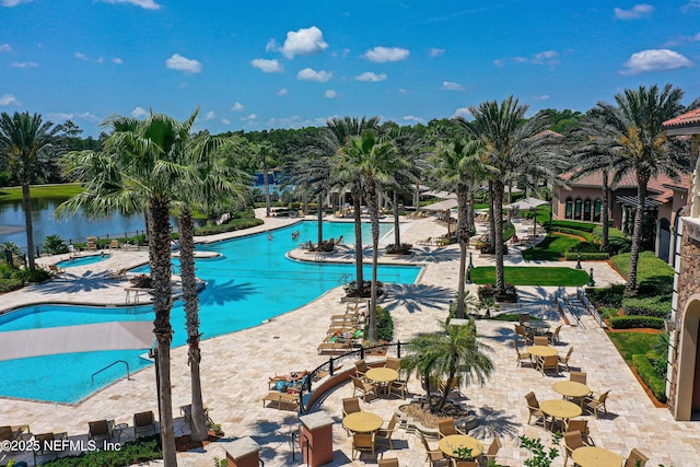 view of pool featuring a patio area and a water view