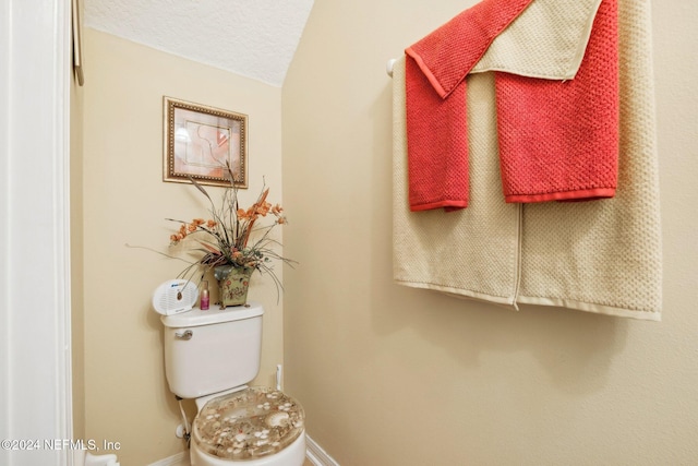 bathroom featuring toilet and a textured ceiling