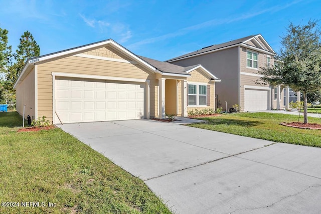 view of front of house featuring a front yard and a garage