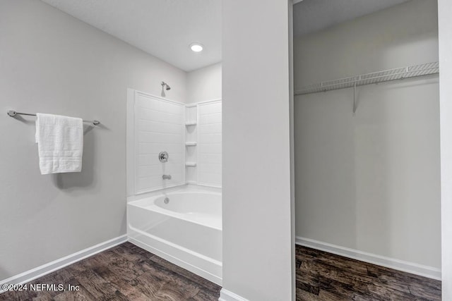 bathroom featuring hardwood / wood-style flooring and shower / bathtub combination