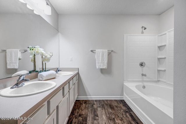 bathroom with vanity, hardwood / wood-style floors, and shower / tub combination