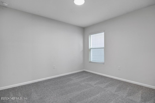 unfurnished room featuring carpet