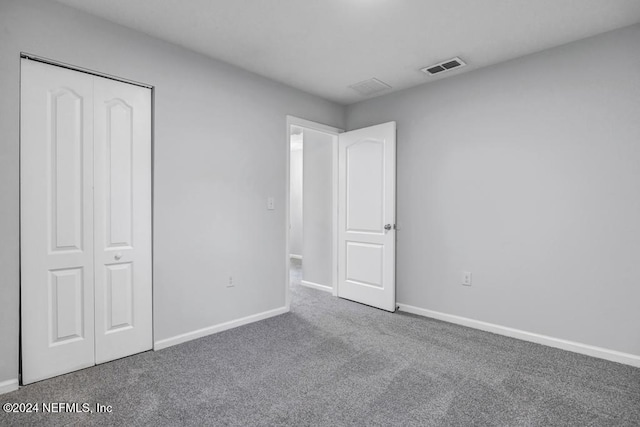 unfurnished bedroom featuring a closet and carpet