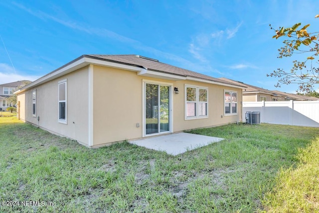 back of property featuring a yard, central air condition unit, and a patio area