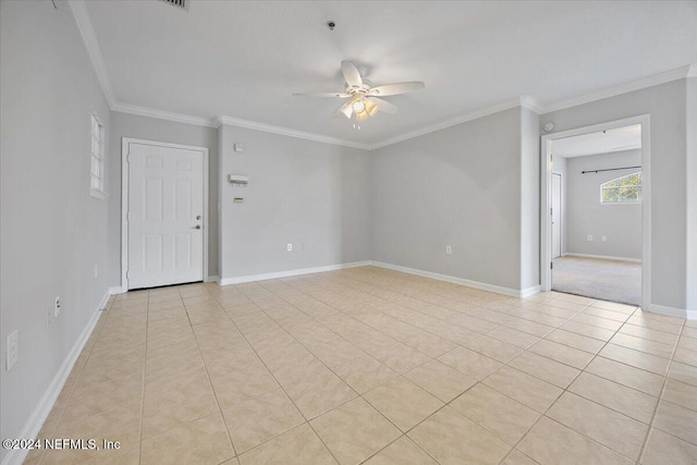 tiled spare room featuring ornamental molding and ceiling fan