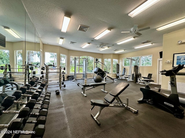 workout area with a textured ceiling and ceiling fan