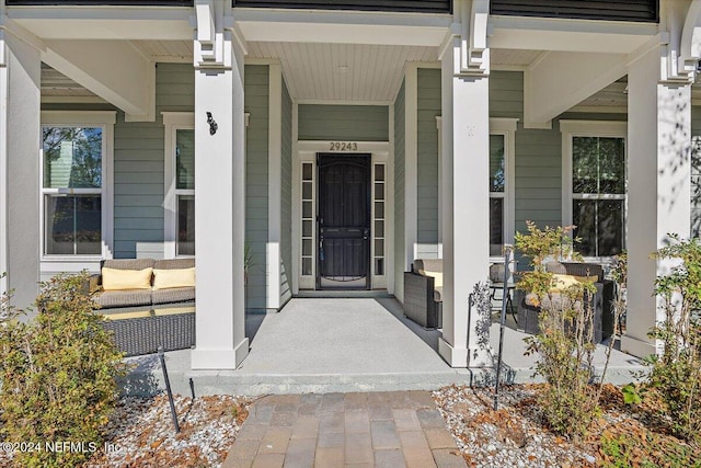 view of exterior entry with covered porch