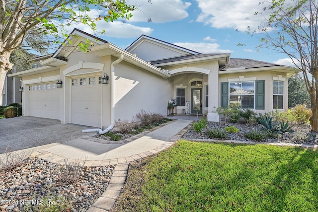 view of front of home with a front yard and a garage