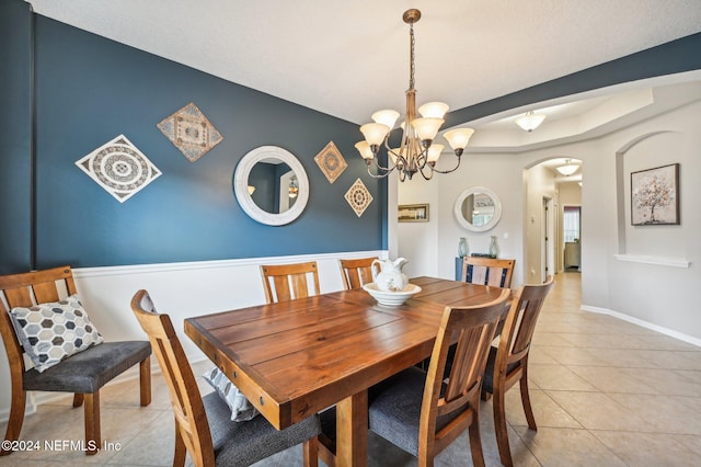 dining space featuring a notable chandelier and light tile patterned flooring