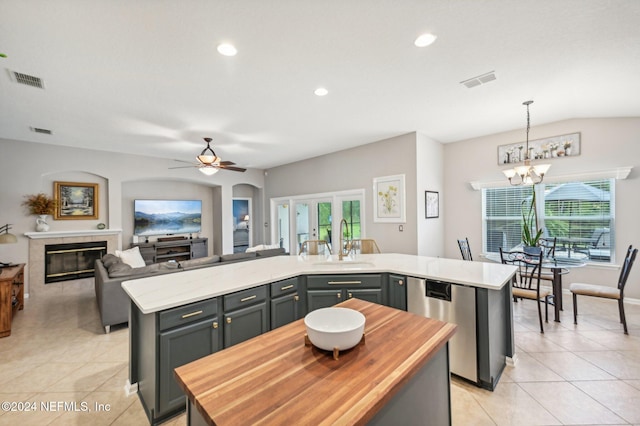 kitchen featuring sink, a wealth of natural light, and a center island with sink