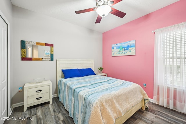 bedroom with ceiling fan and dark hardwood / wood-style flooring