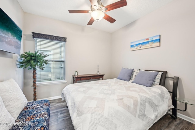 bedroom with dark wood-type flooring and ceiling fan