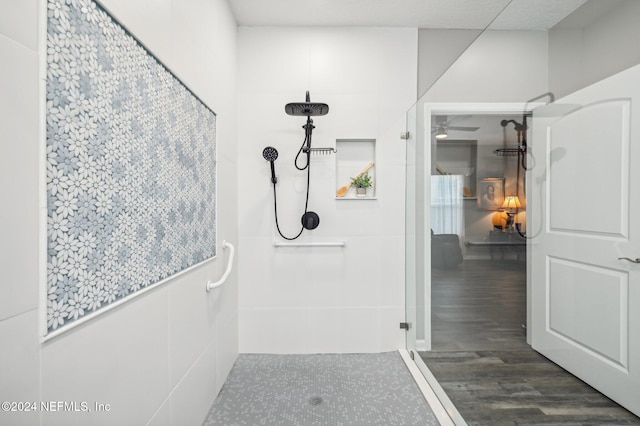 bathroom with a shower and hardwood / wood-style flooring