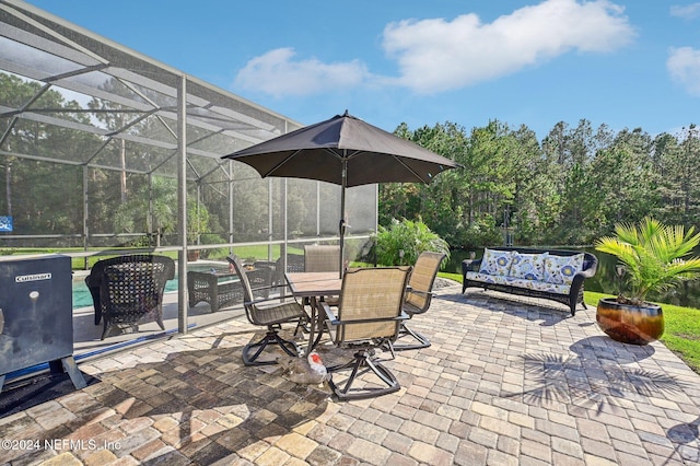 view of patio / terrace featuring glass enclosure