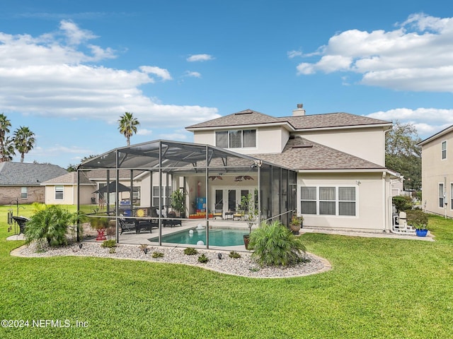 back of house with a patio, ceiling fan, a lawn, and glass enclosure