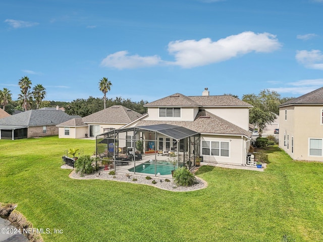 back of house featuring a yard, a patio area, and a lanai