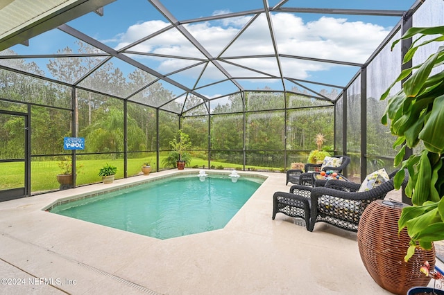 view of pool featuring a patio area, a lawn, and glass enclosure