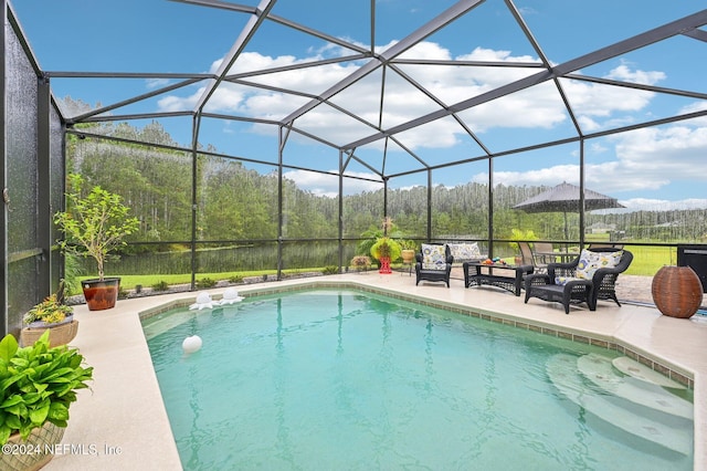 view of swimming pool featuring a patio area, an outdoor hangout area, and glass enclosure