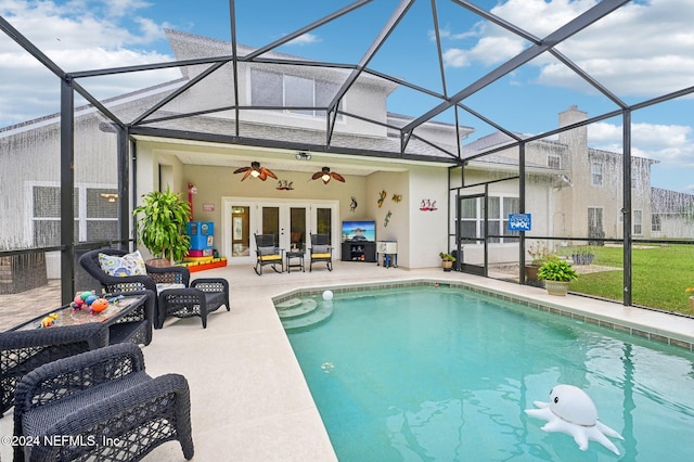 view of pool featuring glass enclosure, an outdoor hangout area, ceiling fan, a patio area, and french doors