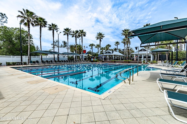 view of swimming pool featuring a patio and a gazebo