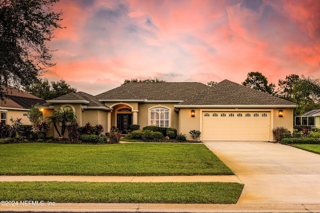 view of front facade featuring a yard and a garage