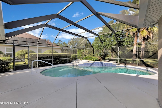 view of swimming pool featuring a patio, a jacuzzi, a lanai, and pool water feature