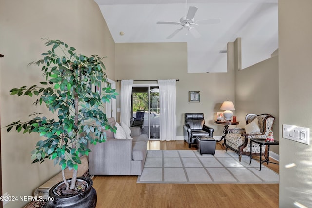 living room featuring high vaulted ceiling, light wood-type flooring, and ceiling fan