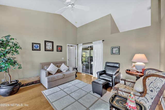 living room featuring vaulted ceiling, light hardwood / wood-style flooring, and ceiling fan