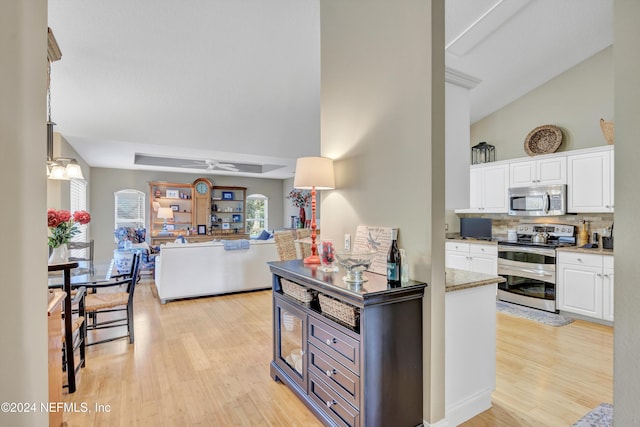 kitchen with appliances with stainless steel finishes, light wood-type flooring, white cabinetry, and ceiling fan