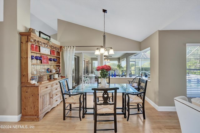 dining space with light hardwood / wood-style flooring, lofted ceiling, and a wealth of natural light