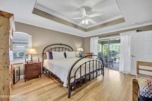 bedroom with ceiling fan, light hardwood / wood-style floors, multiple windows, and access to exterior