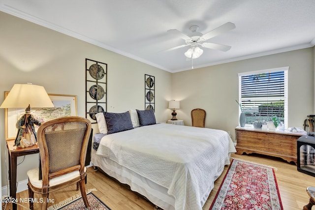 bedroom with ceiling fan, ornamental molding, and light wood-type flooring