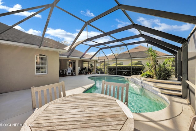 view of swimming pool featuring a patio, a lanai, and pool water feature