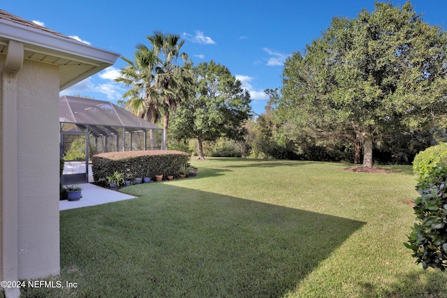 view of yard featuring a lanai