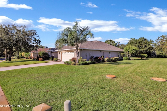 view of side of property featuring a yard and a garage