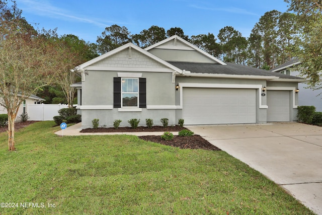 view of front of home featuring a garage and a front yard