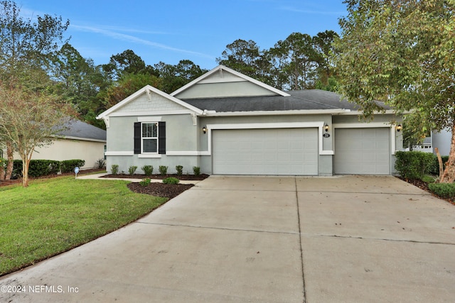 view of front facade with a garage and a front lawn