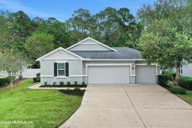 ranch-style house featuring a front lawn and a garage