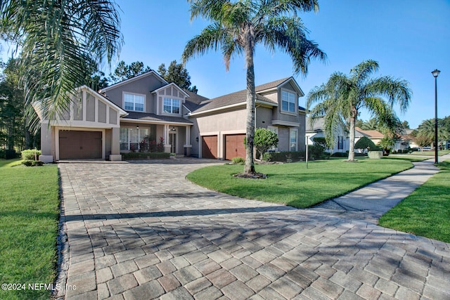 view of front of house with a front yard and a garage